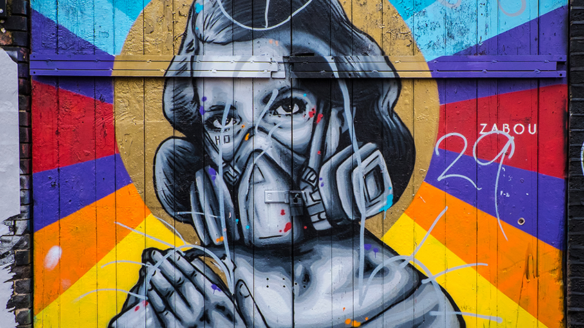 Brick Lane street art - graffiti woman with gas mask