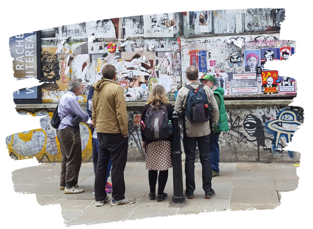 Unseen Tours Guide Pete shows visitors street art on Brick Lane