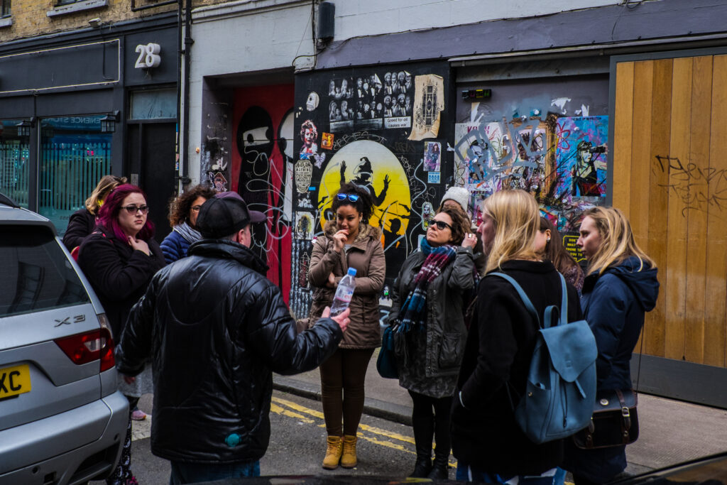 Ben explaining a piece of street art to the people on his tour.