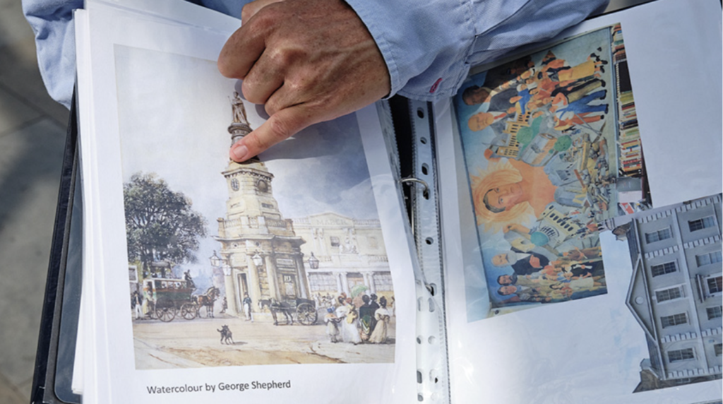 Ben points to a copy of a watercolour by George Shepherd printed into his guide book